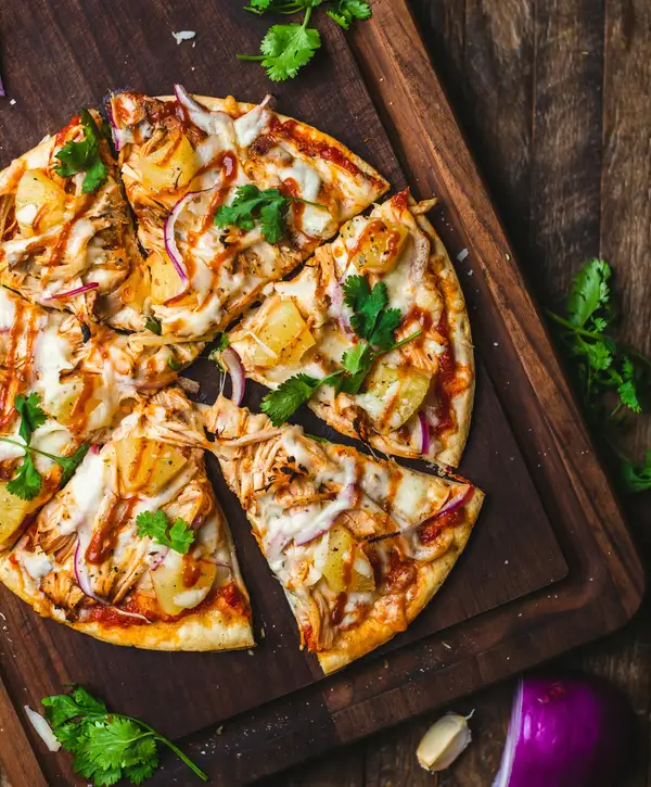 A slice of New York-style pizza reheated in the oven on a preheated sheet pan, crust crisp and cheese sizzling