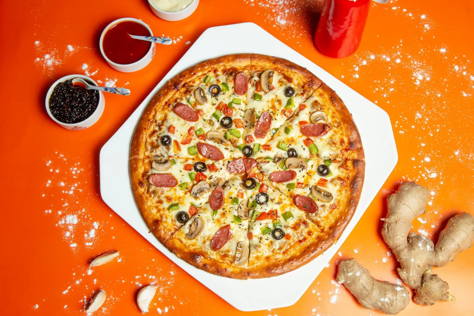 Ooni pizza dough ball on a floured surface, stretched and ready to launch into a high-heat pizza oven