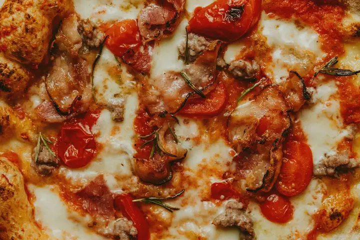 Pizza with tomatoes and cheese, the classic Margherita-style topping combination on a thin crust